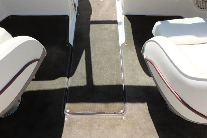 Slide: The Image of Interior of a 2004 Cobalt 200 boat with white seats and dark carpet. - 22