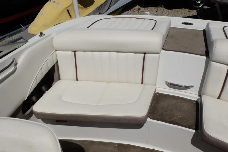 Slide: The Image of White leather seating on a 2004 Cobalt 200 boat, featuring brown accents. - 23