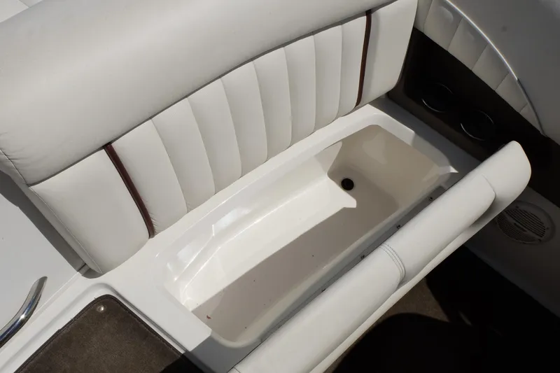 Slide: The Image of White leather seating with storage compartment in a 2004 Cobalt 200 boat. - 26