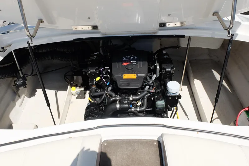 Slide: The Image of Engine compartment of a 2004 Cobalt 200 boat, featuring a MerCruiser MPI engine. - 28