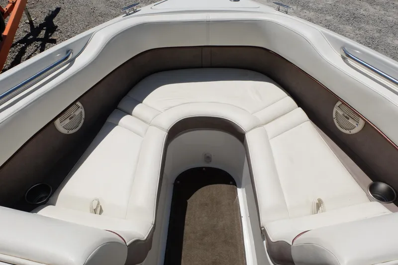 Slide: The Image of Interior of 2004 Cobalt 200 boat with white cushioned seating and speakers. - 4