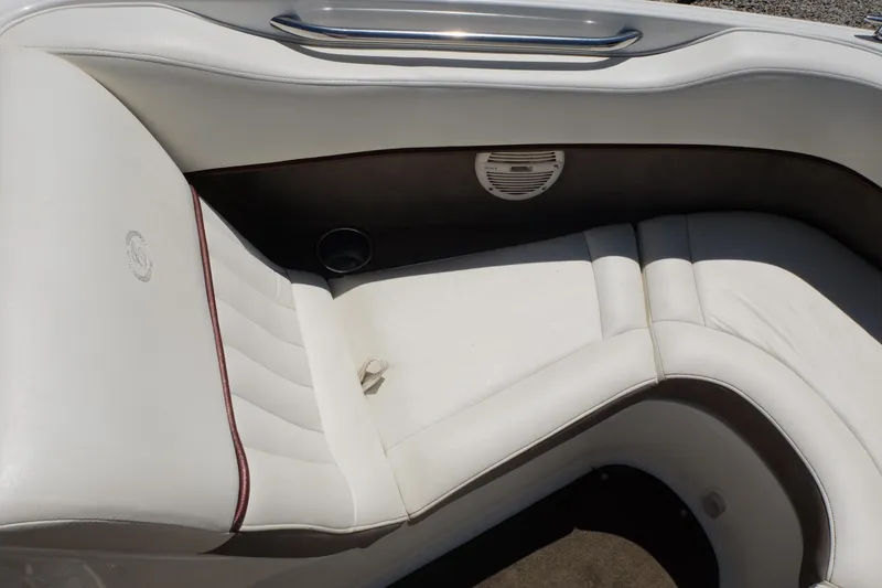 Slide: The Image of White leather seating in a 2004 Cobalt 200 boat, featuring a speaker and elegant design. - 5