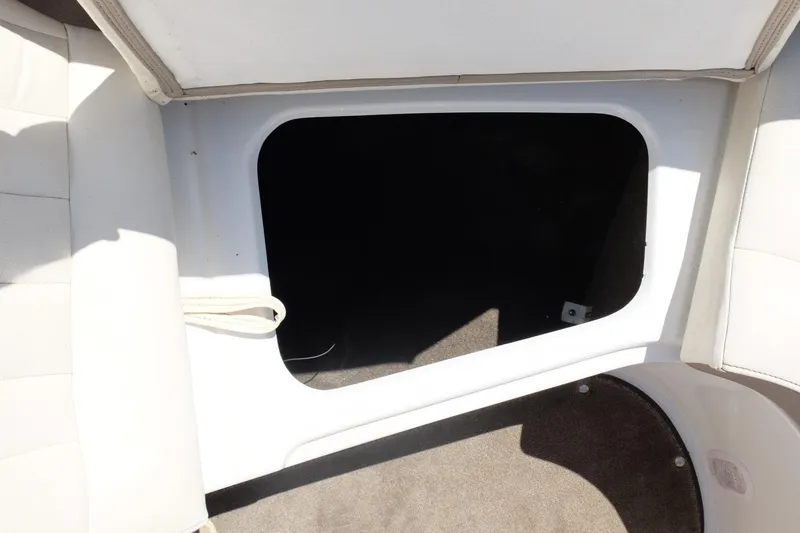 Slide: The Image of Open storage compartment in a 2004 Cobalt 200 boat interior. - 7