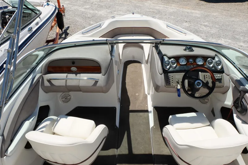 Slide: The Image of Interior of a 2004 Cobalt 200 boat with steering wheel and seating. - 8