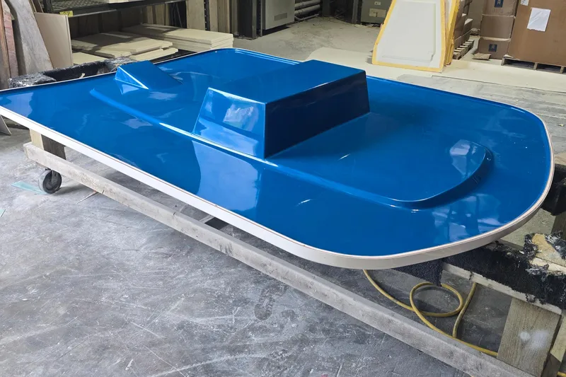 Slide: The Image of Blue Albury Brothers 23 boat hull in workshop, 2027 model. - 2