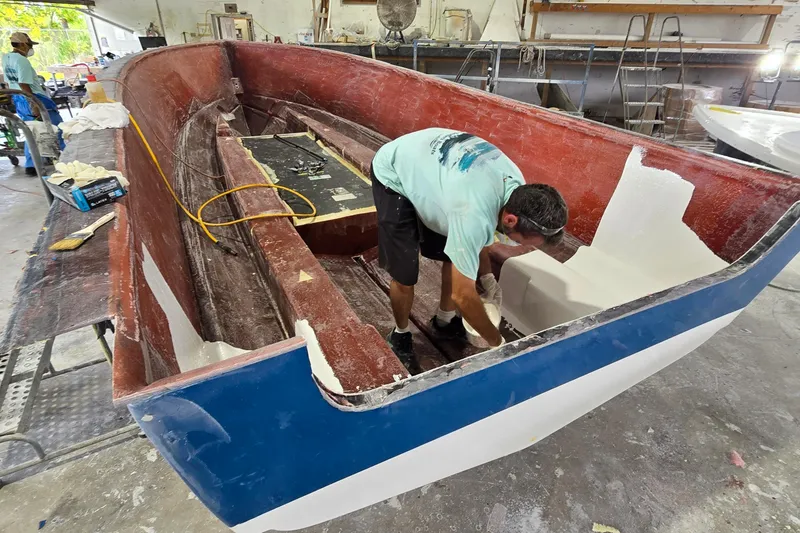 Slide: The Image of Man working on 2027 Albury Brothers 23 boat construction in a workshop. - 3