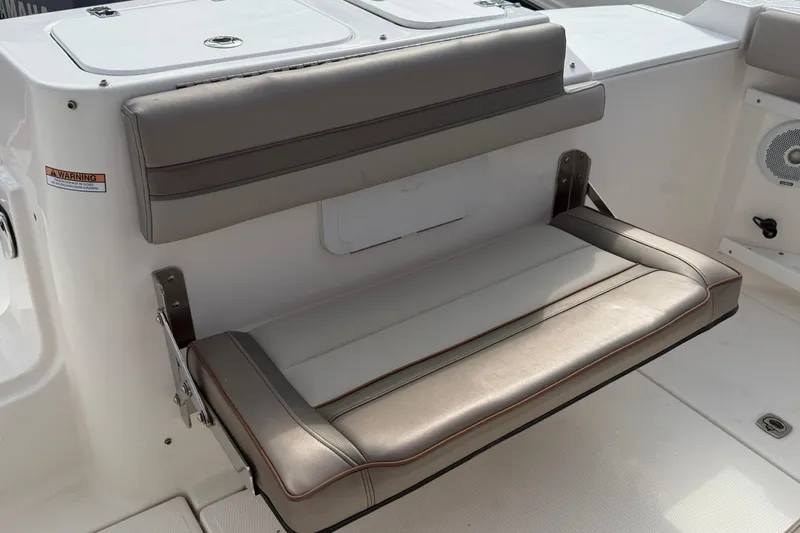 Slide: The Image of Foldable seat on a 2020 Solara S-250 CW boat, featuring cushioned upholstery. - 12