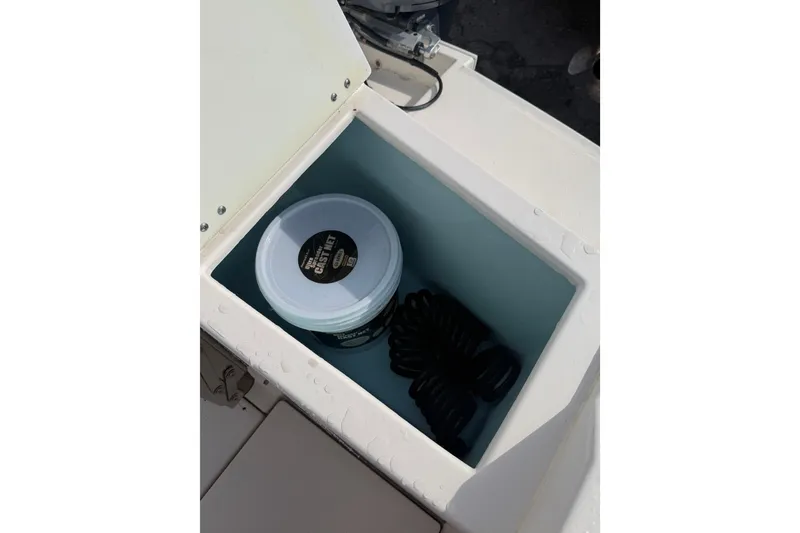 Slide: The Image of Storage compartment in 2020 Solara S-250 CW boat with cleaning supplies and coiled rope. - 22