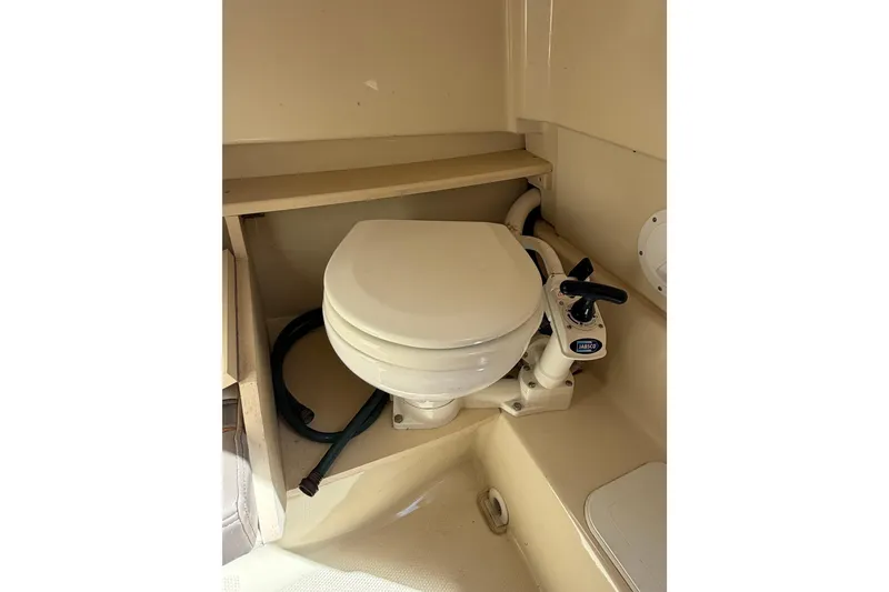 Slide: The Image of Compact marine toilet in 2020 Solara S-250 CW boat, featuring Jabsco manual pump. - 26
