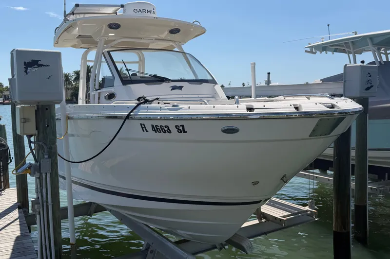 Slide: The Image of 2020 Solara S-250 CW boat docked, featuring Garmin equipment, in a sunny marina setting. - 3