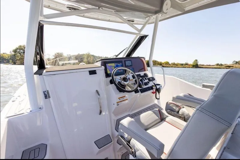 Slide: The Image of 2020 Solara S-250 CW boat cockpit with steering wheel and navigation system on a sunny day. - 33