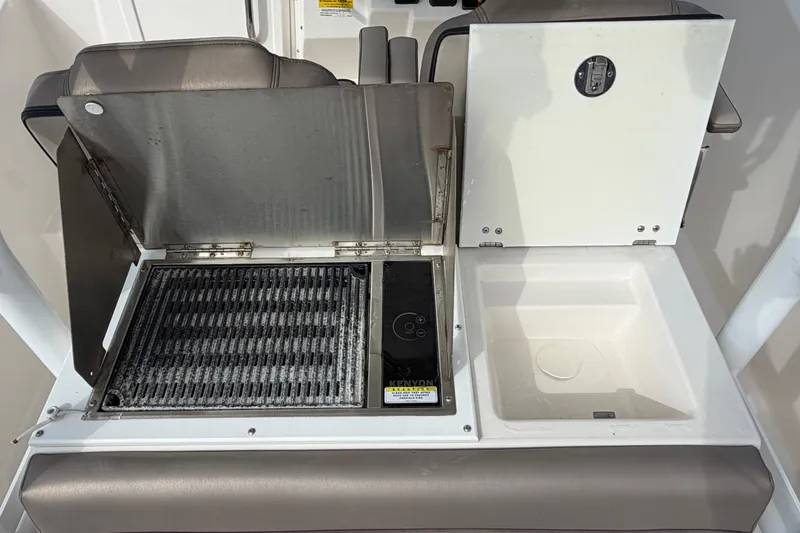 Slide: The Image of 2020 Solara S-250 CW boat grill and sink setup, featuring stainless steel and white surfaces. - 9