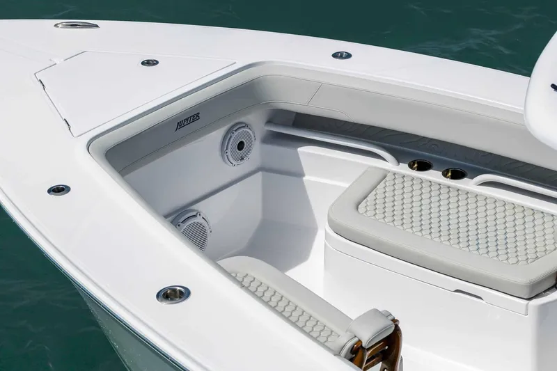 Slide: The Image of Manufacturer Provided Image: 2026 Jupiter 30 boat interior with cushioned seating and speakers, showcasing luxury design. - 4