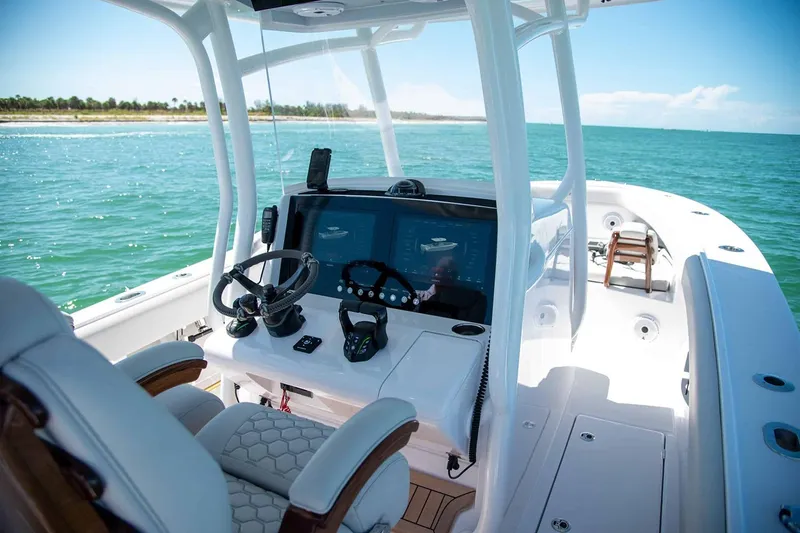 Slide: The Image of Manufacturer Provided Image: Modern Jupiter 30 boat cockpit with advanced controls, cruising on clear blue waters, 2026 model. - 5