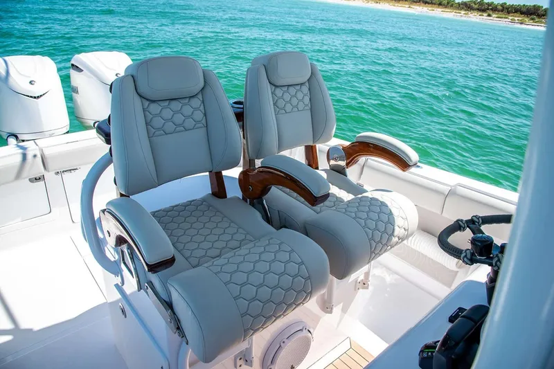 Slide: The Image of Manufacturer Provided Image: Luxurious seating on a 2026 Jupiter 30 boat, overlooking clear blue ocean waters. - 6