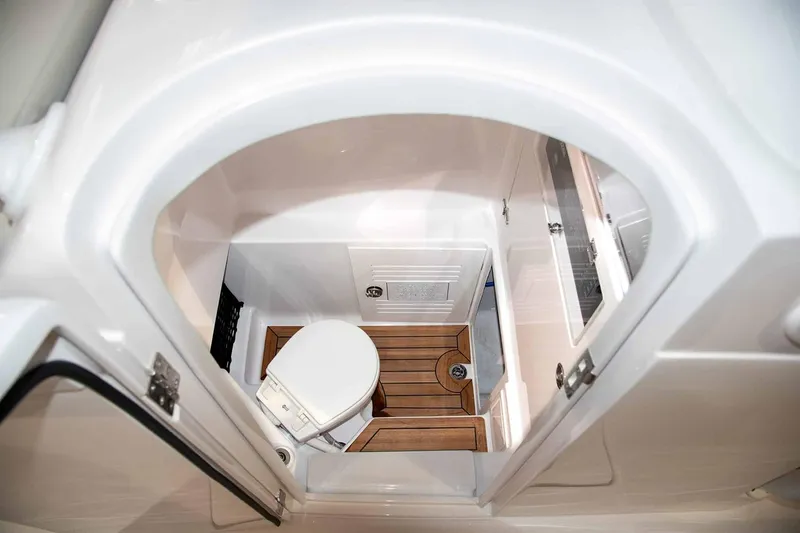 Slide: The Image of Manufacturer Provided Image: Compact marine bathroom in 2026 Jupiter 30 boat with wooden flooring and modern fixtures. - 9
