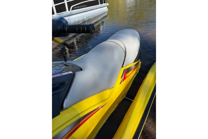 Slide: The Image of 2004 Sea-Doo GTX 4-TEC Supercharged jet ski in water, featuring yellow and gray design. - 6