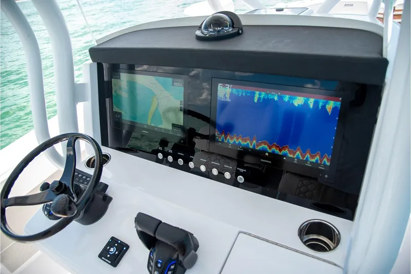Slide: The Image of Manufacturer Provided Image: Helm of 2026 Jupiter 32 boat with advanced navigation displays and controls. - 4