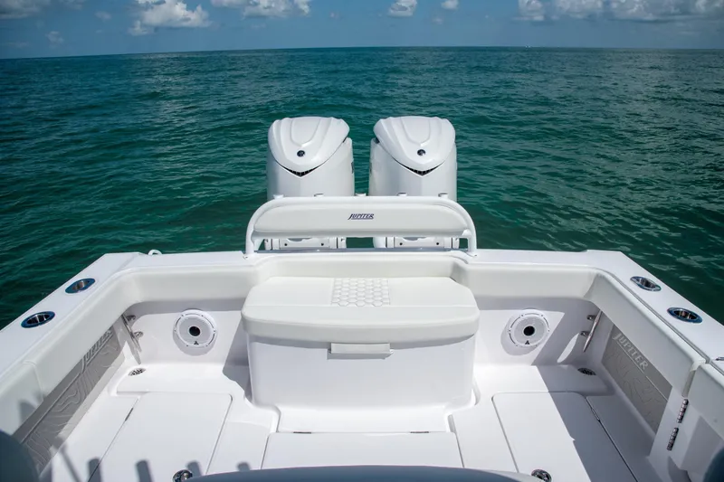 Slide: The Image of Manufacturer Provided Image: Sleek 2026 Jupiter 32 boat deck with dual engines on open sea. - 6