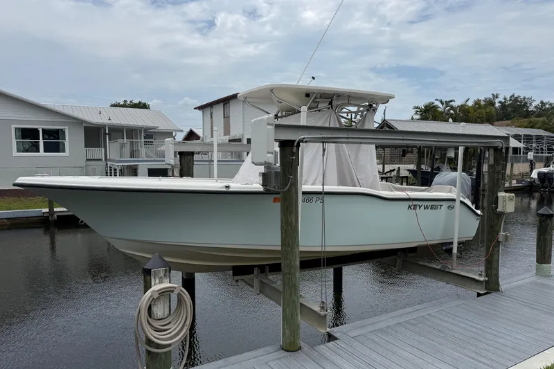 The Image of 2014 Key West 239 FS boat docked on a lift by a canal. - 0