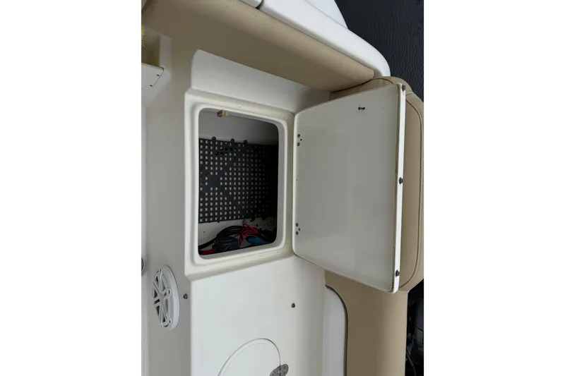 Slide: The Image of Open storage compartment on a 2014 Key West 239 FS boat interior. - 10
