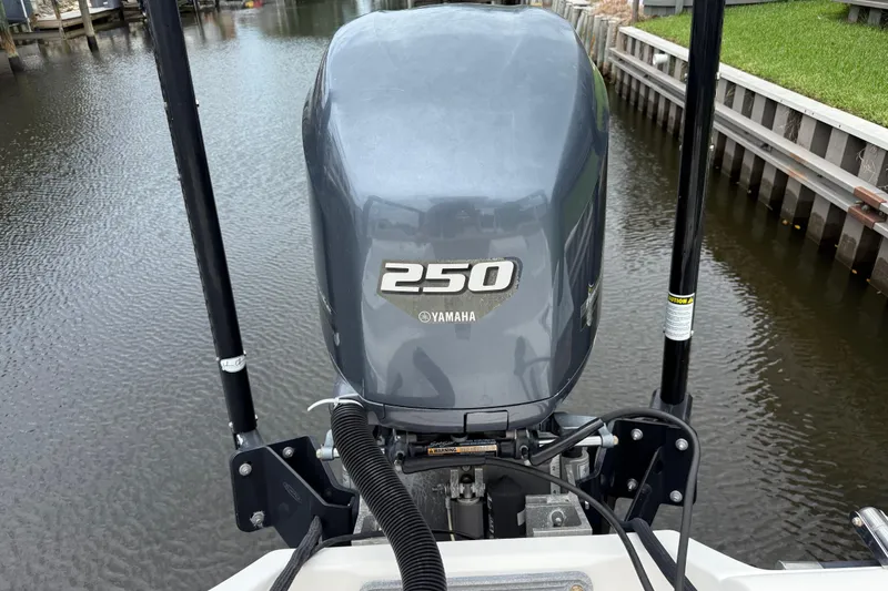 Slide: The Image of Yamaha 250 outboard motor on 2014 Key West 239 FS boat, docked in calm water. - 12
