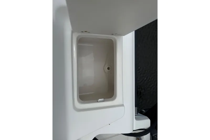 Slide: The Image of 2014 Key West 239 FS boat compartment, open and empty, with white interior. - 13