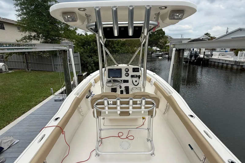 Slide: The Image of 2014 Key West 239 FS boat with center console, docked near a canal. - 17