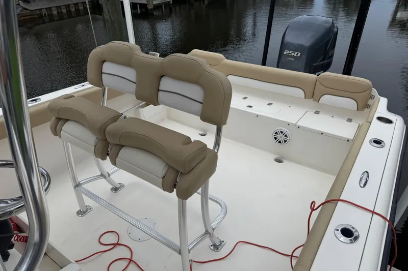 Slide: The Image of 2014 Key West 239 FS boat interior with seating and Yamaha 250 engine. - 18