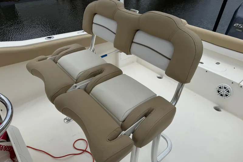 Slide: The Image of 2014 Key West 239 FS boat seating with beige and white cushioned design. - 19