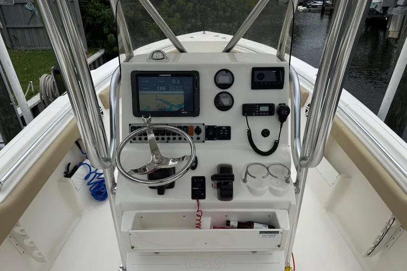 Slide: The Image of 2014 Key West 239 FS boat console with steering wheel and navigation equipment. - 20