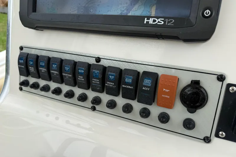 Slide: The Image of Control panel of a 2014 Key West 239 FS boat with various switches and HDS12 display. - 22