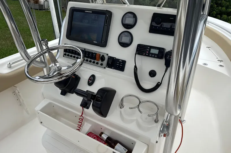 Slide: The Image of 2014 Key West 239 FS boat console with steering wheel, gauges, and navigation equipment. - 26