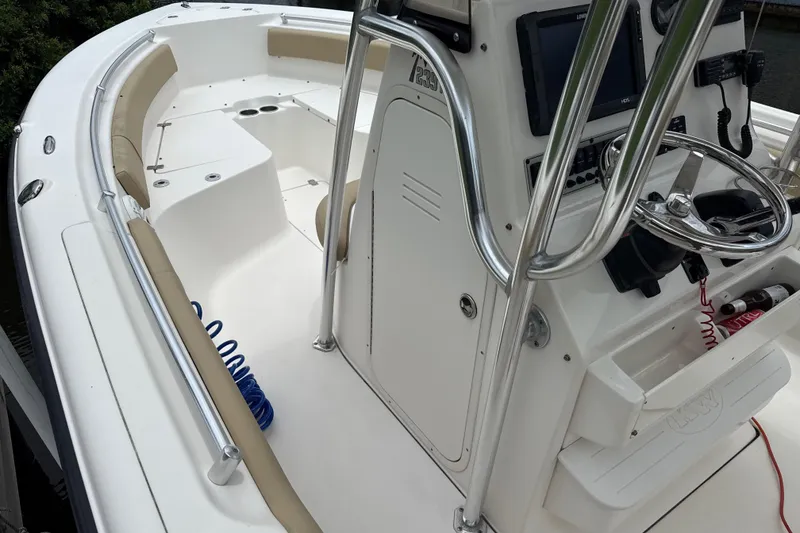 Slide: The Image of 2014 Key West 239 FS boat interior with steering console and seating area. - 27