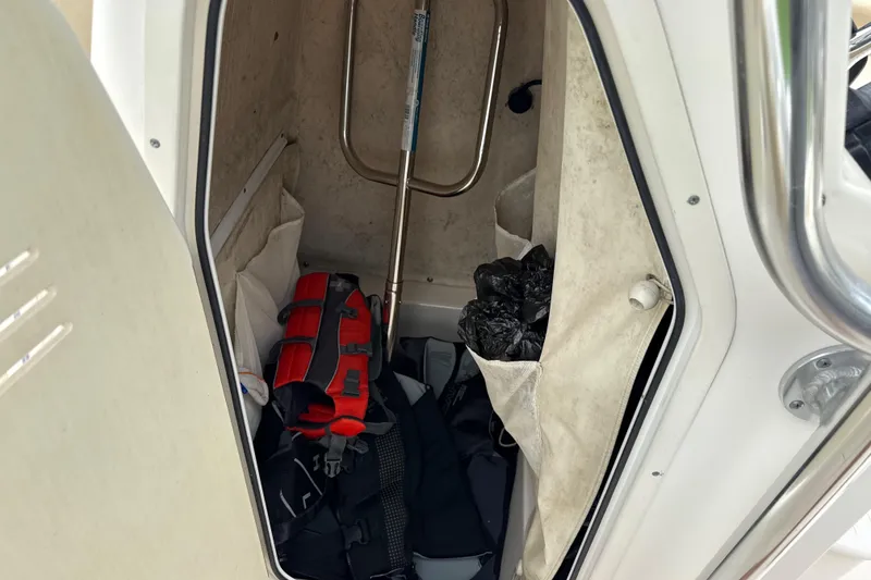 Slide: The Image of Storage compartment of a 2014 Key West 239 FS boat with life jacket and gear. - 28