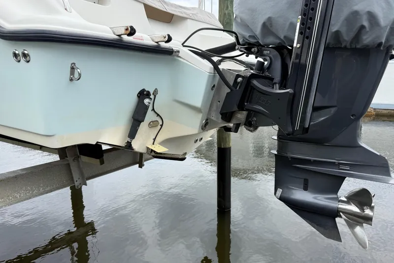 Slide: The Image of 2014 Key West 239 FS boat with outboard motor, docked on water. - 3