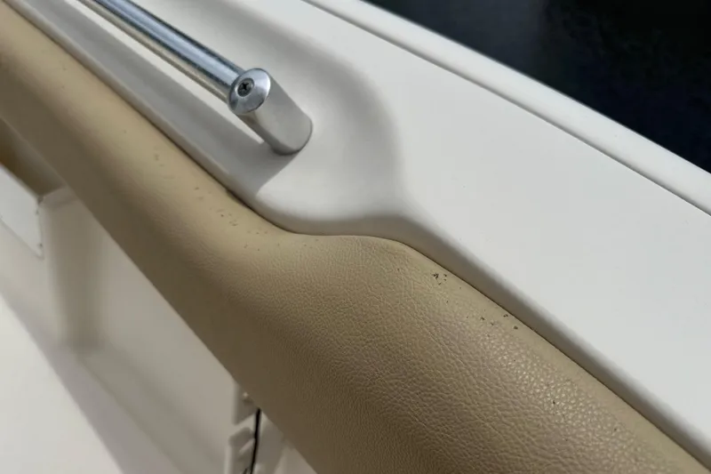 Slide: The Image of Close-up of 2014 Key West 239 FS boat interior, featuring beige upholstery and metal railing. - 31