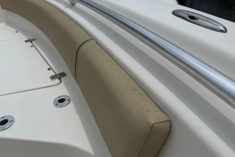 Slide: The Image of 2014 Key West 239 FS boat interior with beige seating and stainless steel railing. - 32