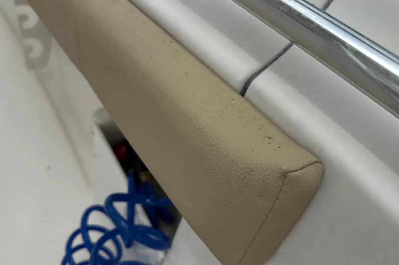 Slide: The Image of Cushioned seat detail on 2014 Key West 239 FS boat with blue coiled hose. - 33