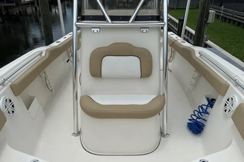Slide: The Image of 2014 Key West 239 FS boat interior with beige seating and stainless steel railings. - 35