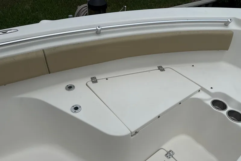 Slide: The Image of 2014 Key West 239 FS boat interior with storage compartment and cup holders. - 38