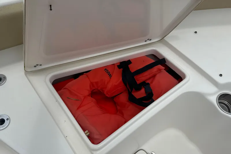 Slide: The Image of Storage compartment on 2014 Key West 239 FS boat with life jackets inside. - 39
