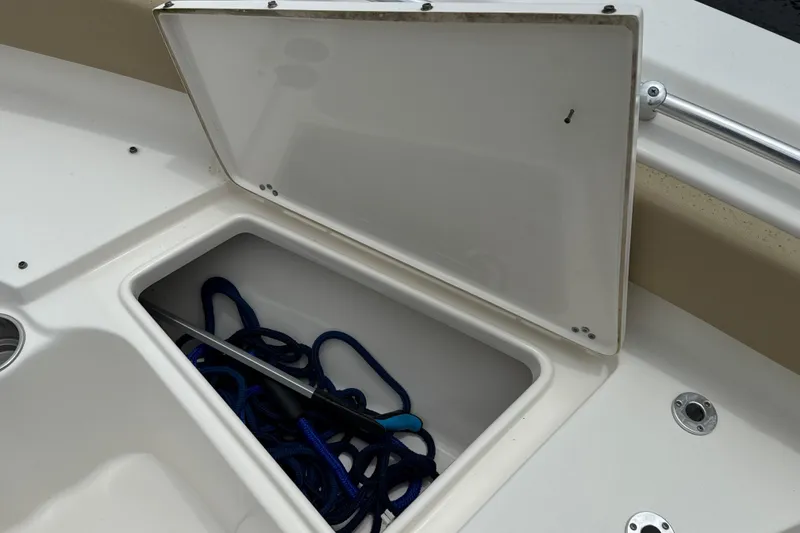 Slide: The Image of Open storage compartment on 2014 Key West 239 FS boat with blue rope inside. - 41