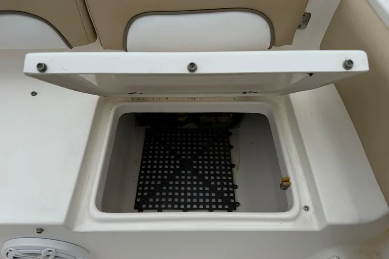 Slide: The Image of Open storage compartment on 2014 Key West 239 FS boat with beige seating. - 7