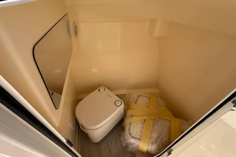 Slide: The Image of Compact bathroom in 2026 Scout 220 Dorado boat with portable toilet and mirror. - 13