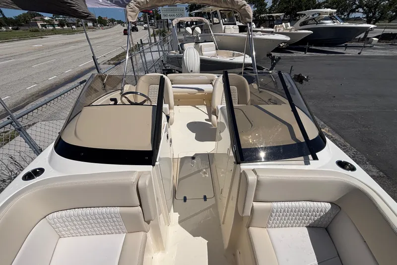 Slide: The Image of 2026 Scout 220 Dorado boat interior with beige seating and dual consoles. - 14