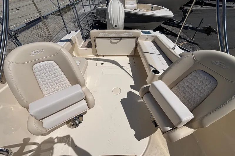 Slide: The Image of 2026 Scout 220 Dorado boat interior with beige seating and sleek design. - 15