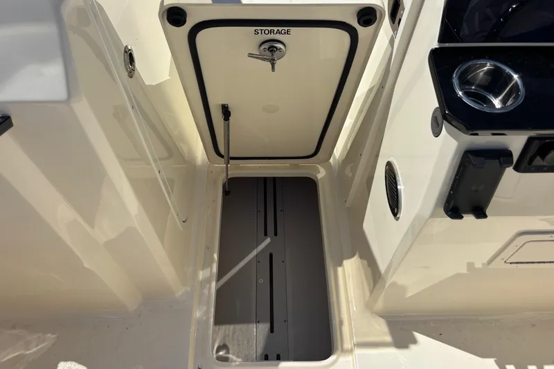 Slide: The Image of Storage compartment on a 2026 Scout 220 Dorado boat, featuring a secure latch. - 17