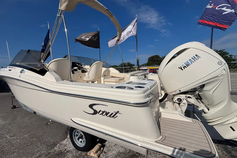 Slide: The Image of 2026 Scout 220 Dorado boat with Yamaha engine, displayed outdoors under blue sky. - 4