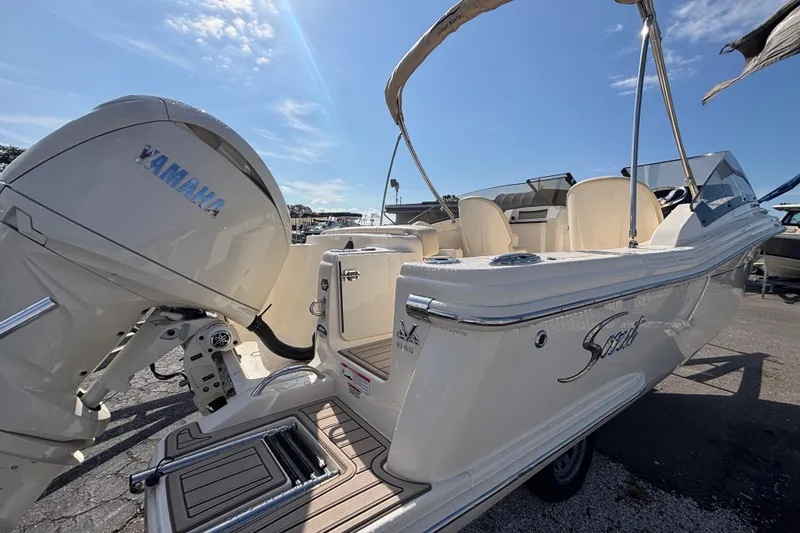 Slide: The Image of 2026 Scout 220 Dorado boat with Yamaha engine, docked under clear blue sky. - 5